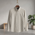 Check shirt: long-sleeve button-up with small dark grid and chest logo