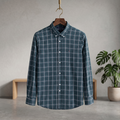 Button-up check shirt, dark bluish-green and navy plaid, long sleeves, button front.
