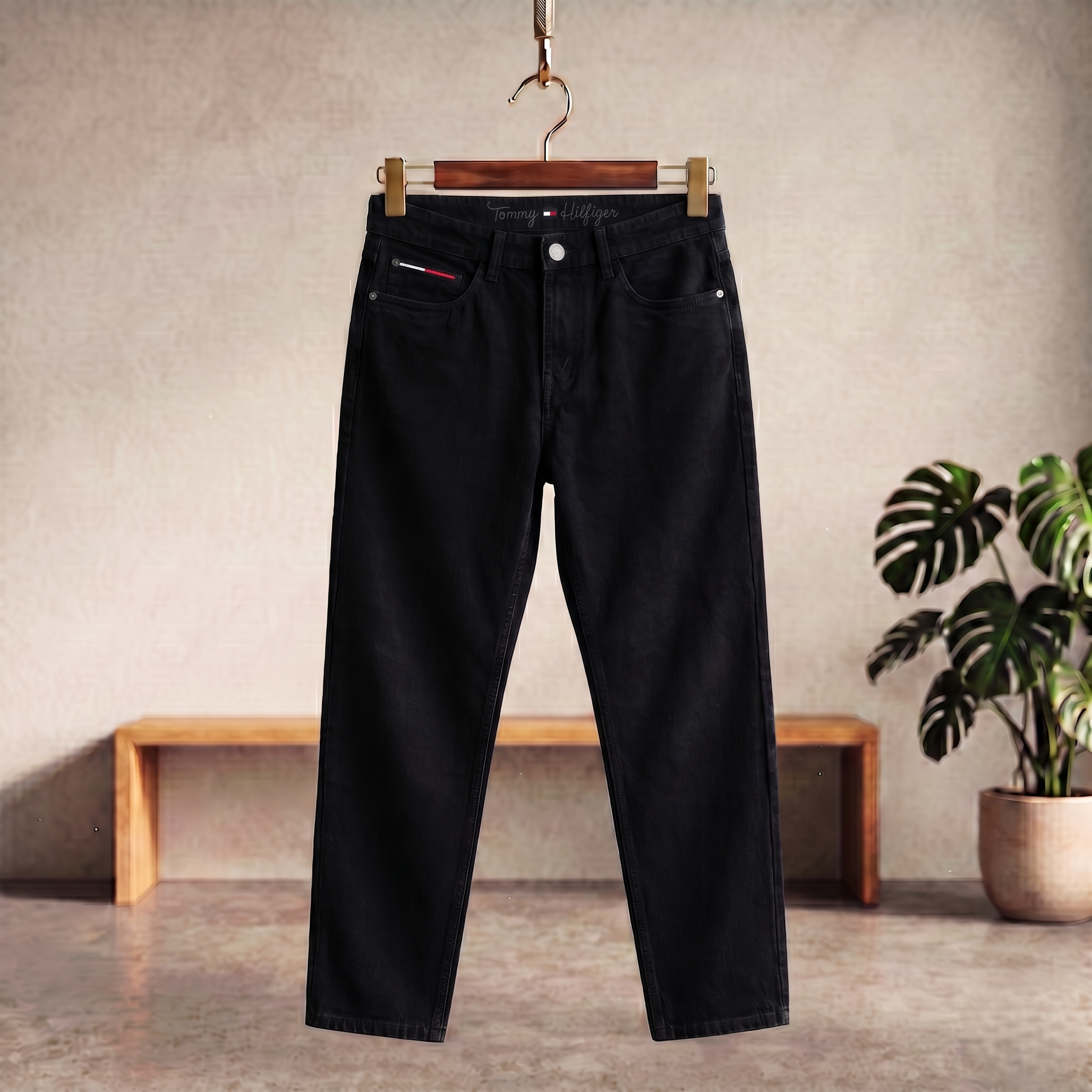 Black denim jeans with straight leg, belt loops, button and zipper front
