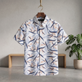 Hawaiian half shirt with short sleeves and collared button front, blue and orange leaf print