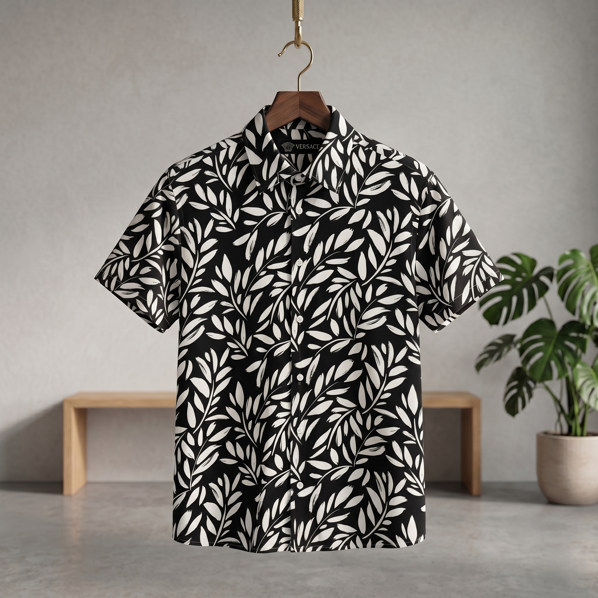 Black Hawaiian half shirt with white leaf print, short sleeves, button-front