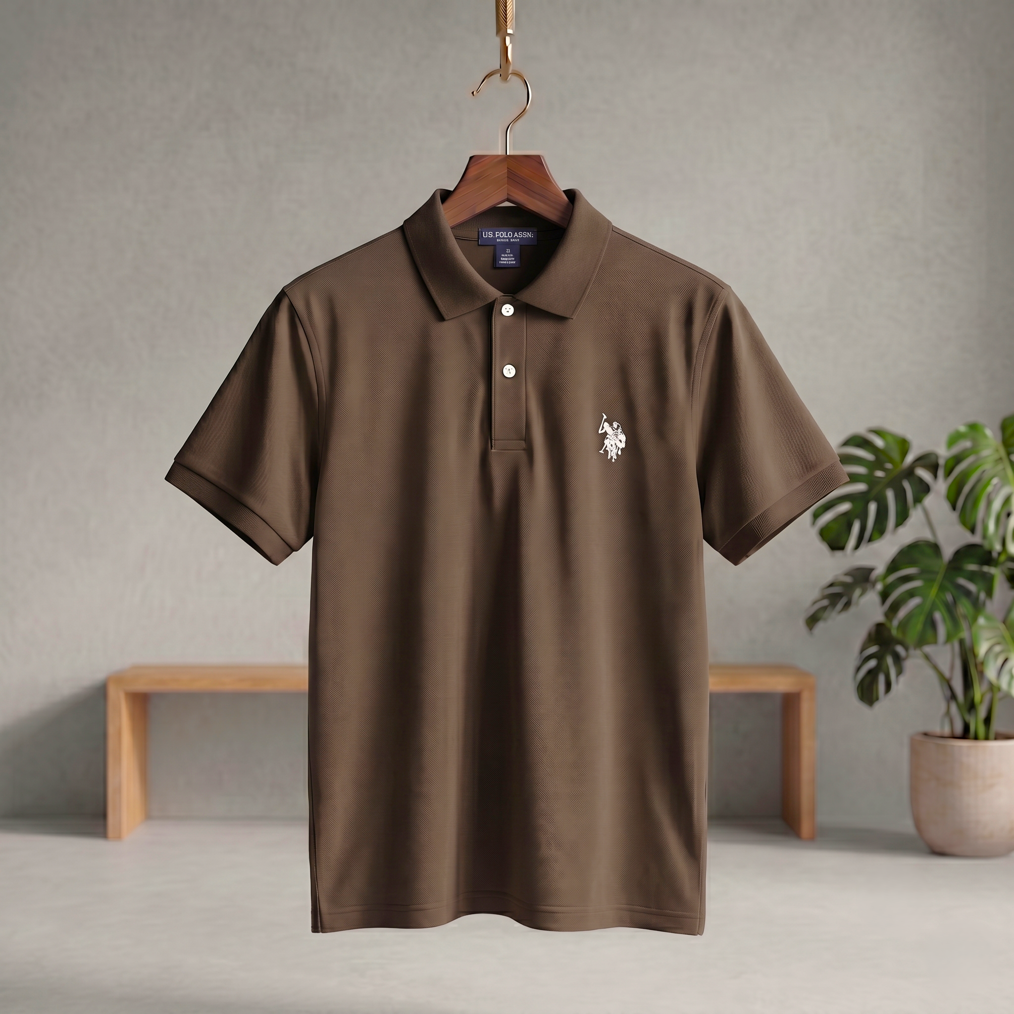 Dark brown polo T-shirt with button placket, collar, short sleeves, and chest logo