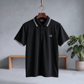 Black polo shirt with white striped collar and sleeve trim, button placket, chest logo