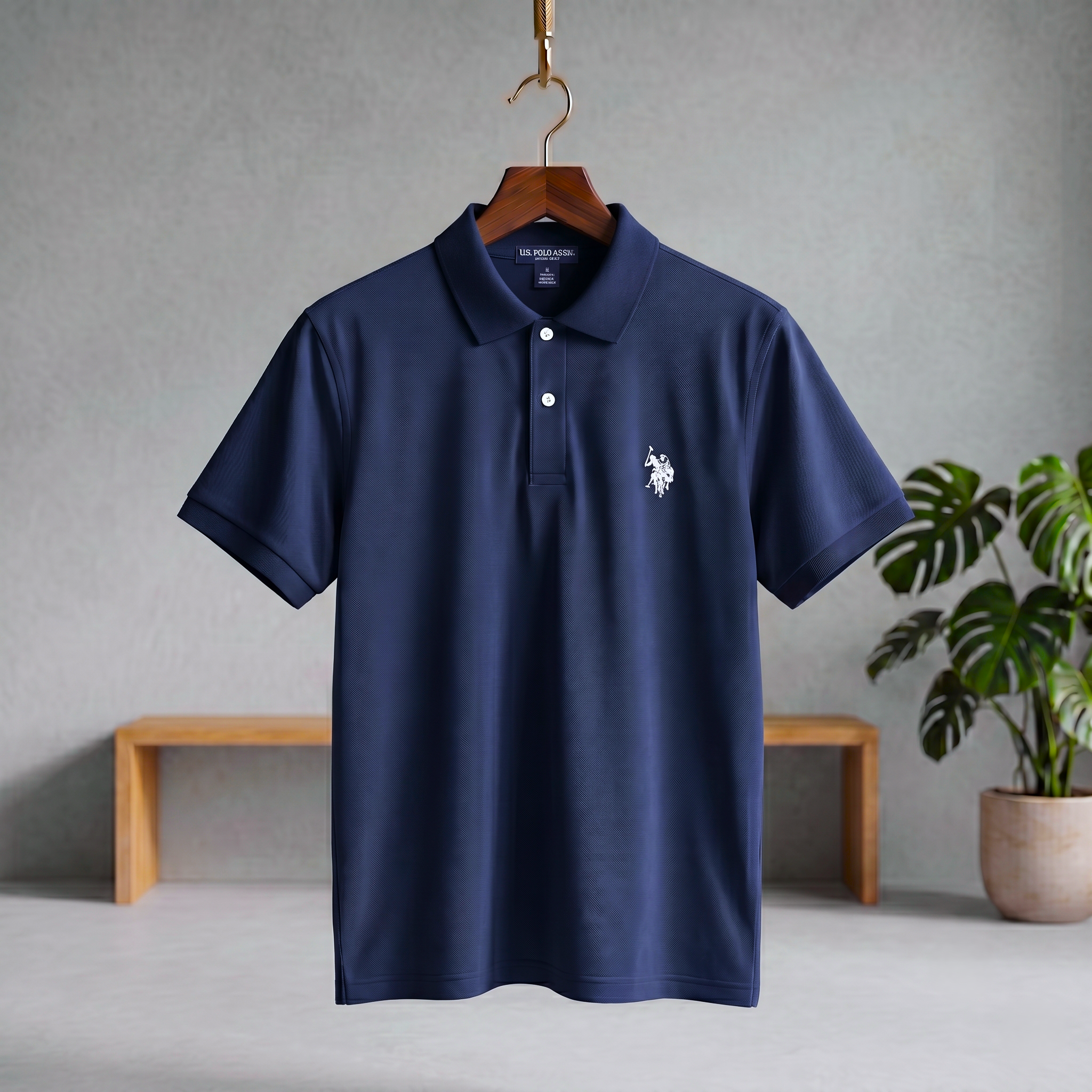 Navy polo T-shirt with button placket and short sleeves, small white crest on chest